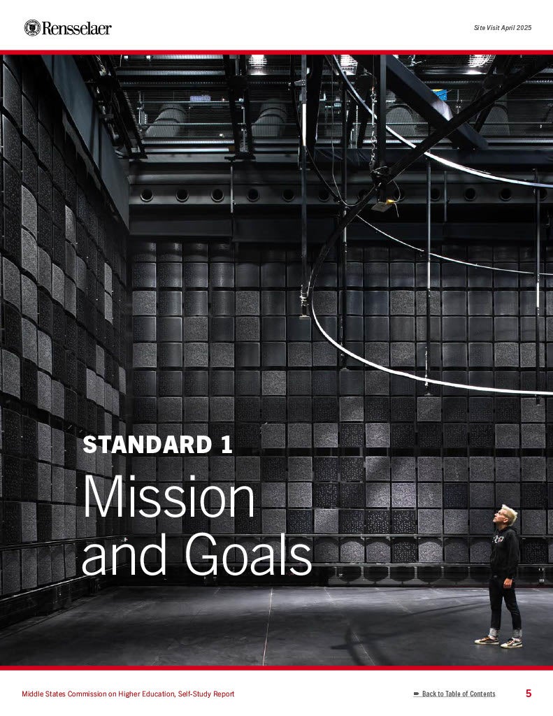 Man standing in a large, black acoustic room Standard 1 - Mission and Goals