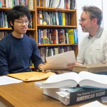 Professor works with a student in his office