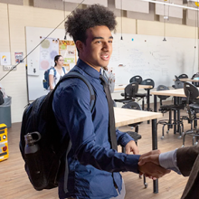 Male student shakes hands with a professor