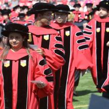 Graduate students walking to Commencement
